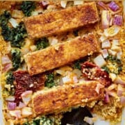 Tofu and quinoa casserole with sun-dried tomatoes, red onions and curly kale.