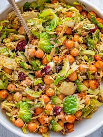Shredded Brussels sprouts, roasted chickpeas, sunflower seeds, and dried cranberries in creamy vegan Caesar dressing.