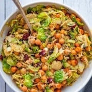 Shredded Brussels sprouts, roasted chickpeas, sunflower seeds, and dried cranberries in creamy vegan Caesar dressing.