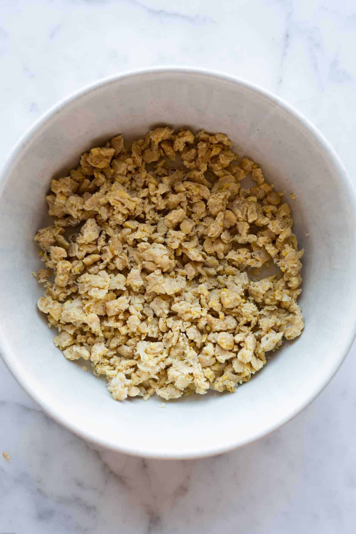 Crumbled tempeh in a glass bowl.