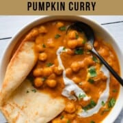 Pantry Chickpea Pumpkin Curry with naan in a white bowl.
