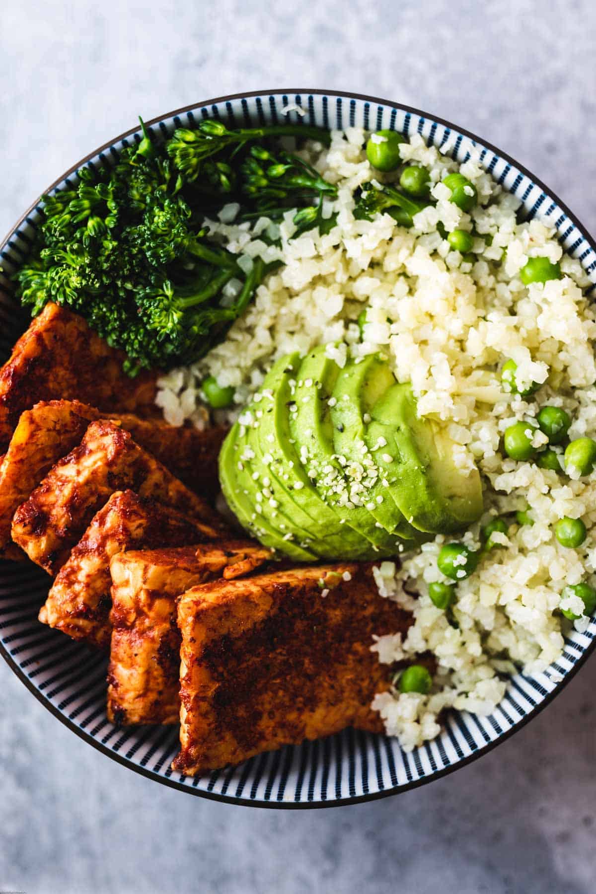 BBQ tempeh, cauliflower rice with green peas, avocado, and broccoli.
