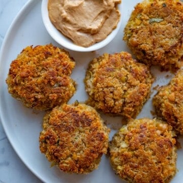 Crispy Baked Vegan Crab Cakes with Artichoke Hearts on a plate with vegan chipotle mayonnaise.