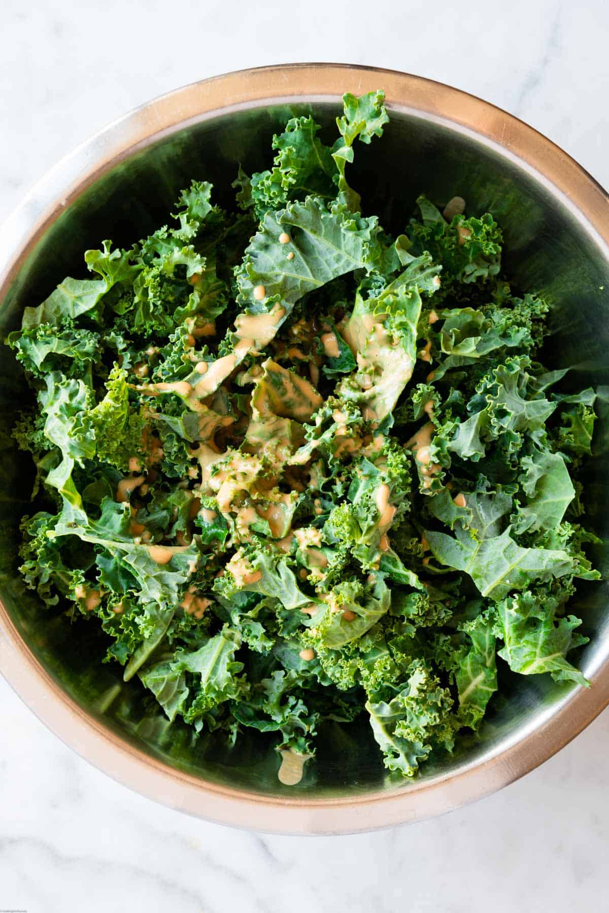 Chopped kale with creamy vegan peanut dressing.