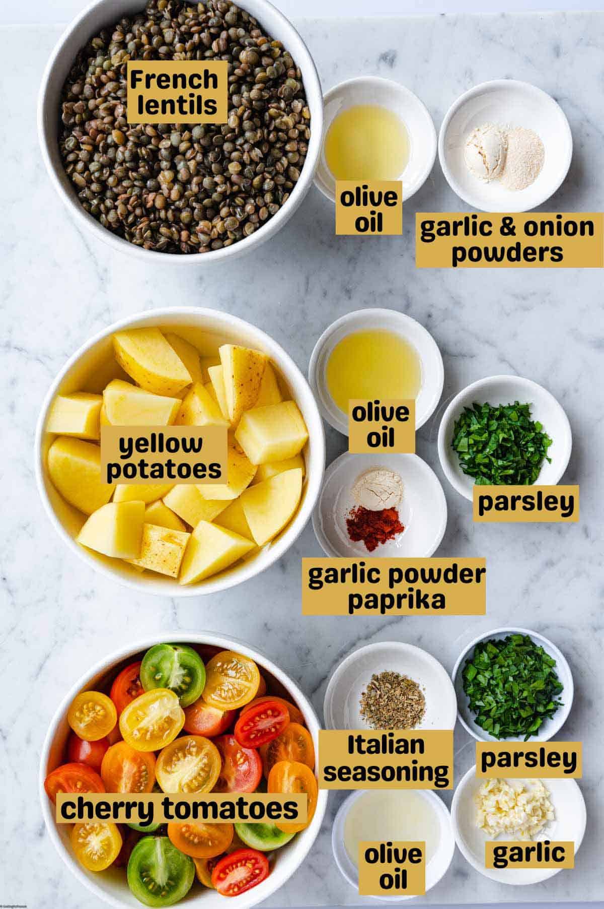 French lentils, cherry tomatoes, cut potatoes, olive oil, garlic powder, onion powder, chopped parsley, minced garlic, paprika, and Italian seasoning, in bowls. For making Warm Roasted Lentil & Potato Salad.