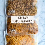 Three reusable sandwich size Ziploc bags with marinated tempeh crumbles.