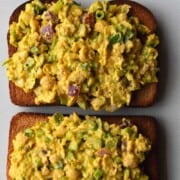 Curried chickpea salad with chopped red onion, celery, and scallions on two slices of whole wheat toast.