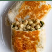 Crispy wraps cut in half with a creamy chickpea and collard green filling.