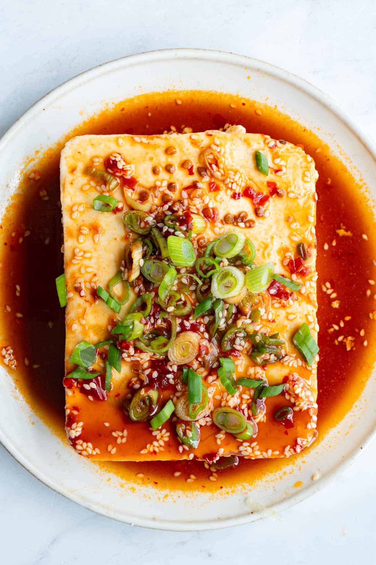 Silken tofu in sesame soy dressing with toasted sesame seeds and chopped scallions.