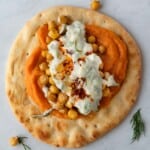 Vegan flatbread wrap with za'atar roasted chickpeas, miso sweet potato, and tzatziki.