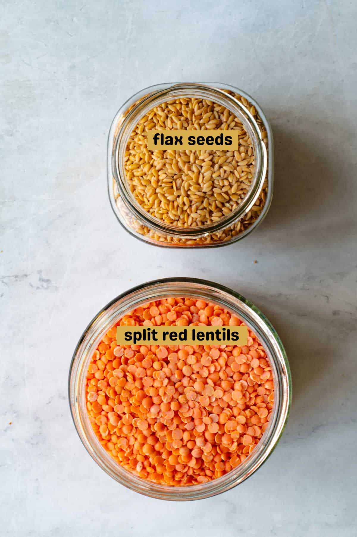 Flax seeds and red lentils in glass jars.