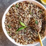 Lemon quinoa topped with fresh herbs and made with tricolor quinoa.