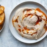 Creamy white bean hummus topped with chili crisp and served with crispy toasts.