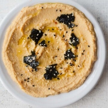 Hummus without tahini on a white plate.