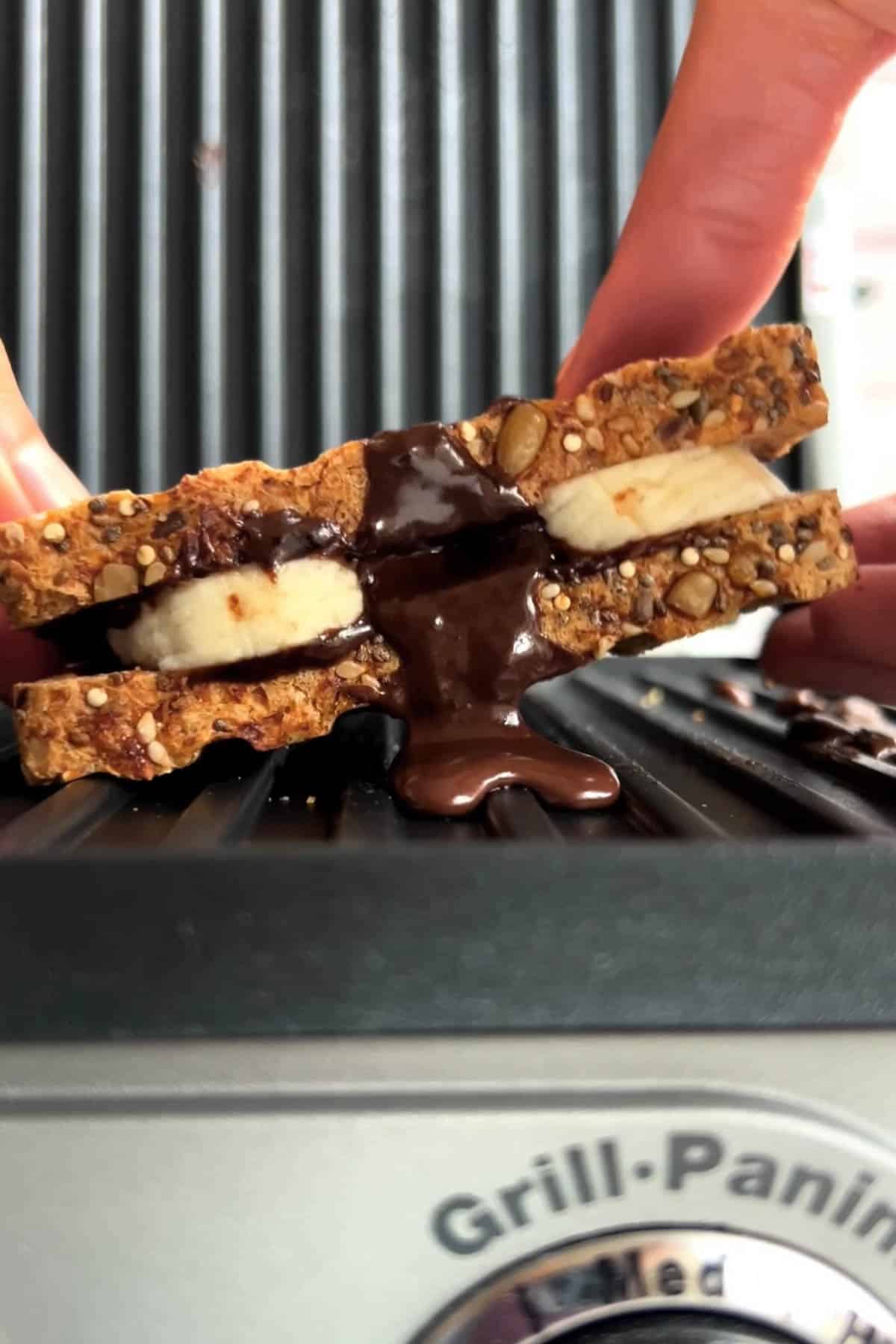 Chocolate spread in a sandwich with banana in a panini press.