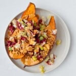Baked sweet potato topped with radicchio salad and tofu meat.