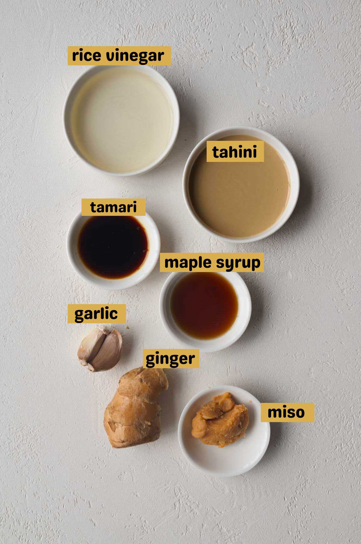 Rice vinegar, tahini, tamari, maple syrup, tamari, garlic, ginger, and white miso.