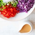 Thai Salad Dressing next to a white bowl of Thai Crunch Salad.