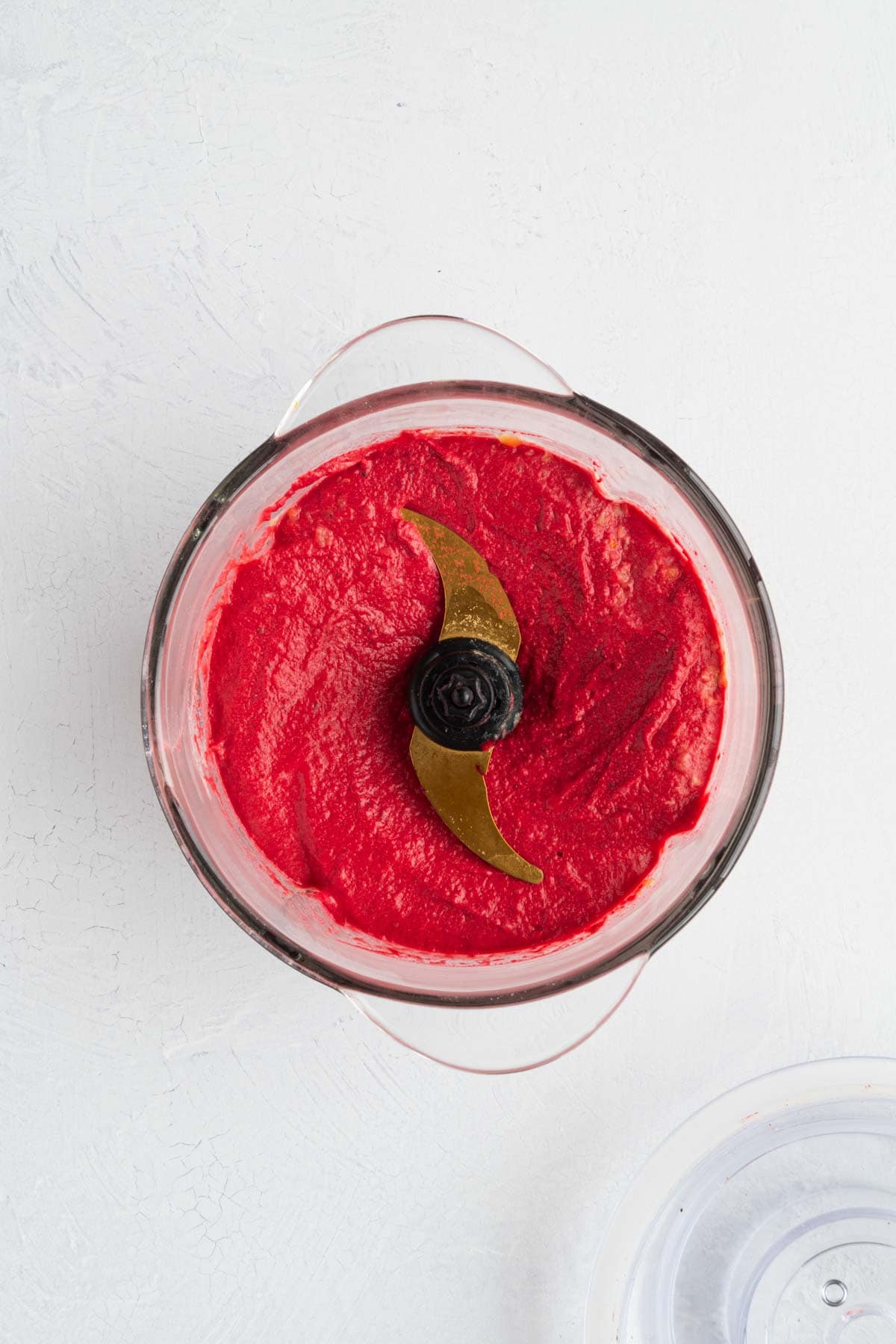 Pink beetroot hummus in the canister of a food processor.