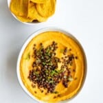 Homemade gluten-free crackers and sweet potato hummus with roasted lentils.