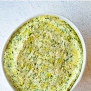 Dairy free cream cheese with kale in a white bowl.