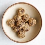 Energy balls for anti-inflammatory snack rolled in crispy quinoa in a bowl.