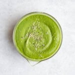 Green miso sauce in a glass bowl with hemp hearts.