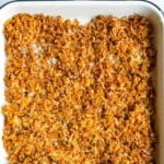 Grated tofu baked until crispy on a white baking sheet.