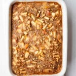 Baked protein oats with apple in a white baking dish.