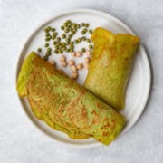 Gluten-free wraps with mung beans and chickpeas on a white plate.