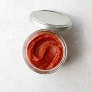 Healthy homemade ketchup in a glass jar.