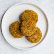 Baked falafel with mung beans on a white plate.