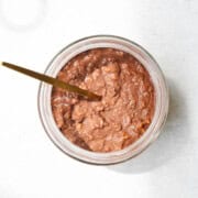 Breakfast Lentils Vegan Porridge in a meal prep container with a spoon.