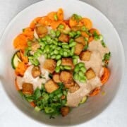 High-fiber protein salad with carrots, zucchini, green onion, cilantro, and edamame in a small serving bowl.