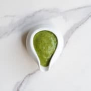 Dill dressing in a white pouring bowl.