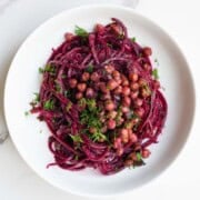 Raw beet salad with chickpeas, pumpkin seeds, and fresh dill.