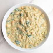 Creamy white beans (high-protein) in a white bowl.