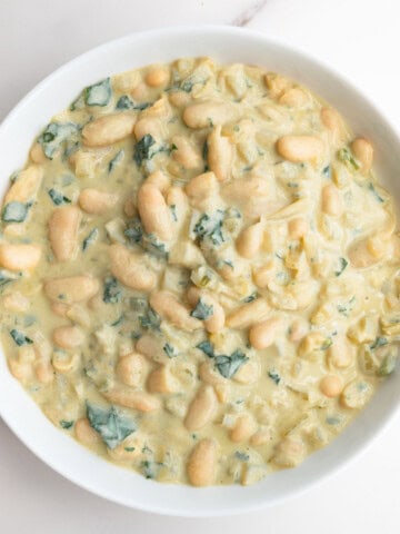 Creamy white beans (high-protein) in a white bowl.