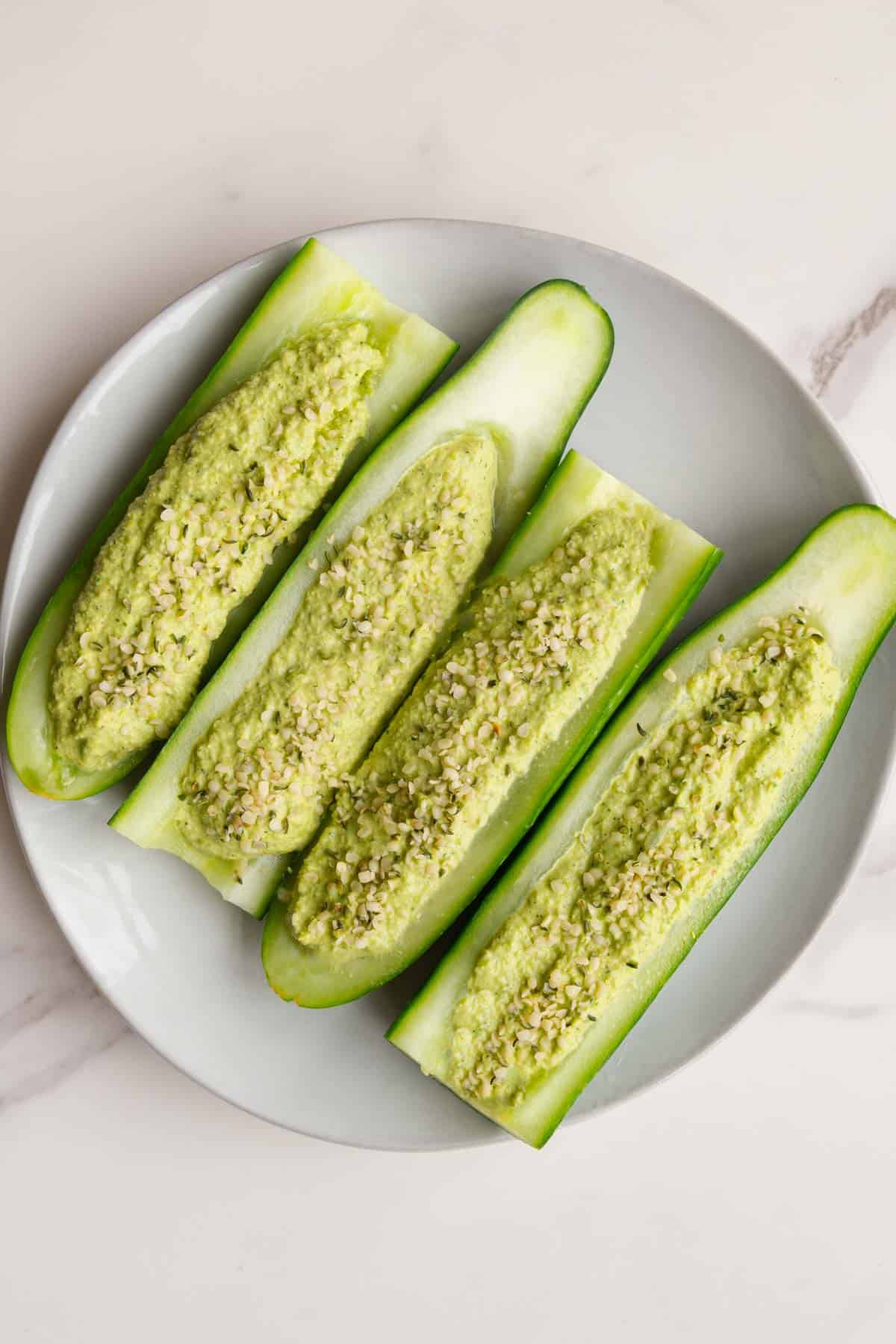 Cucumber boats on a white plate.