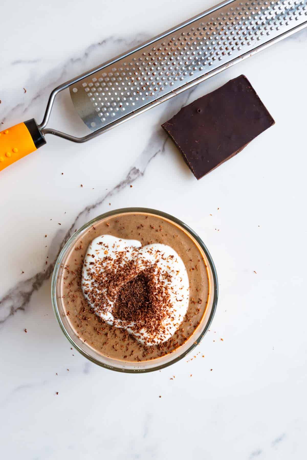 Healthy zucchini chia pudding with a microplane and grated chocolate.