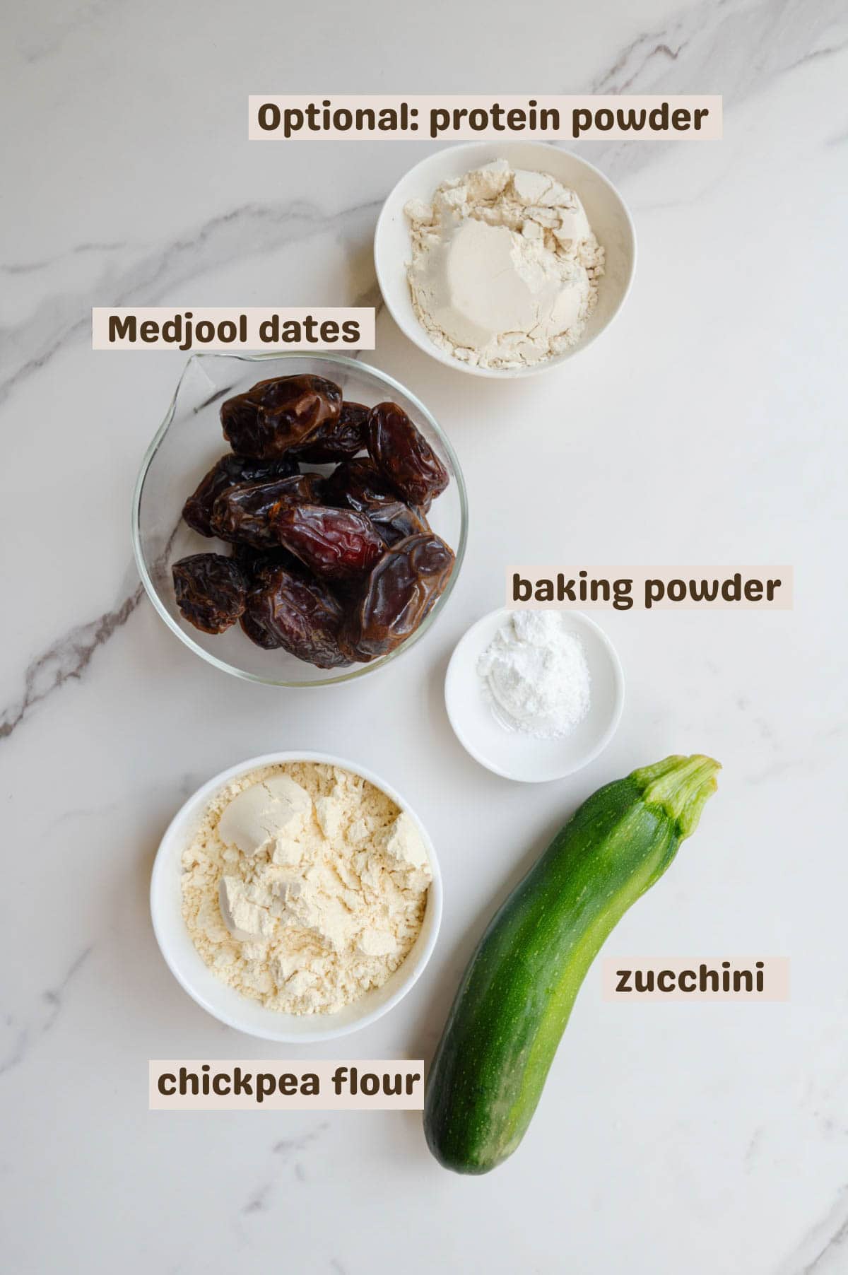 Medjool dates, zucchini, protein powder, chickpea flour, and baking powder.