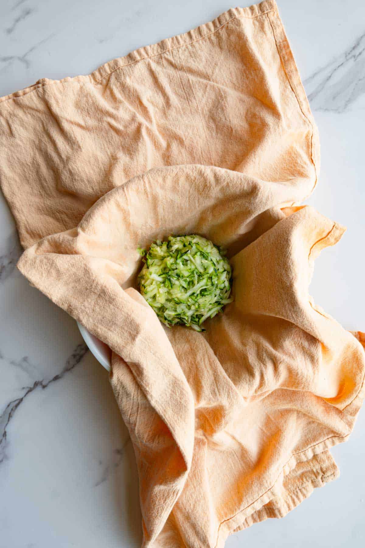 Squeezed grated zucchini in a napkin.