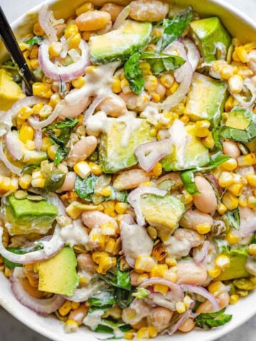 Creamy lemon pepper dressing with High-Protein Bean & Corn Salad: shallot, avocado, corn, basil, jalapeรฑo, pepitas, and white beans.