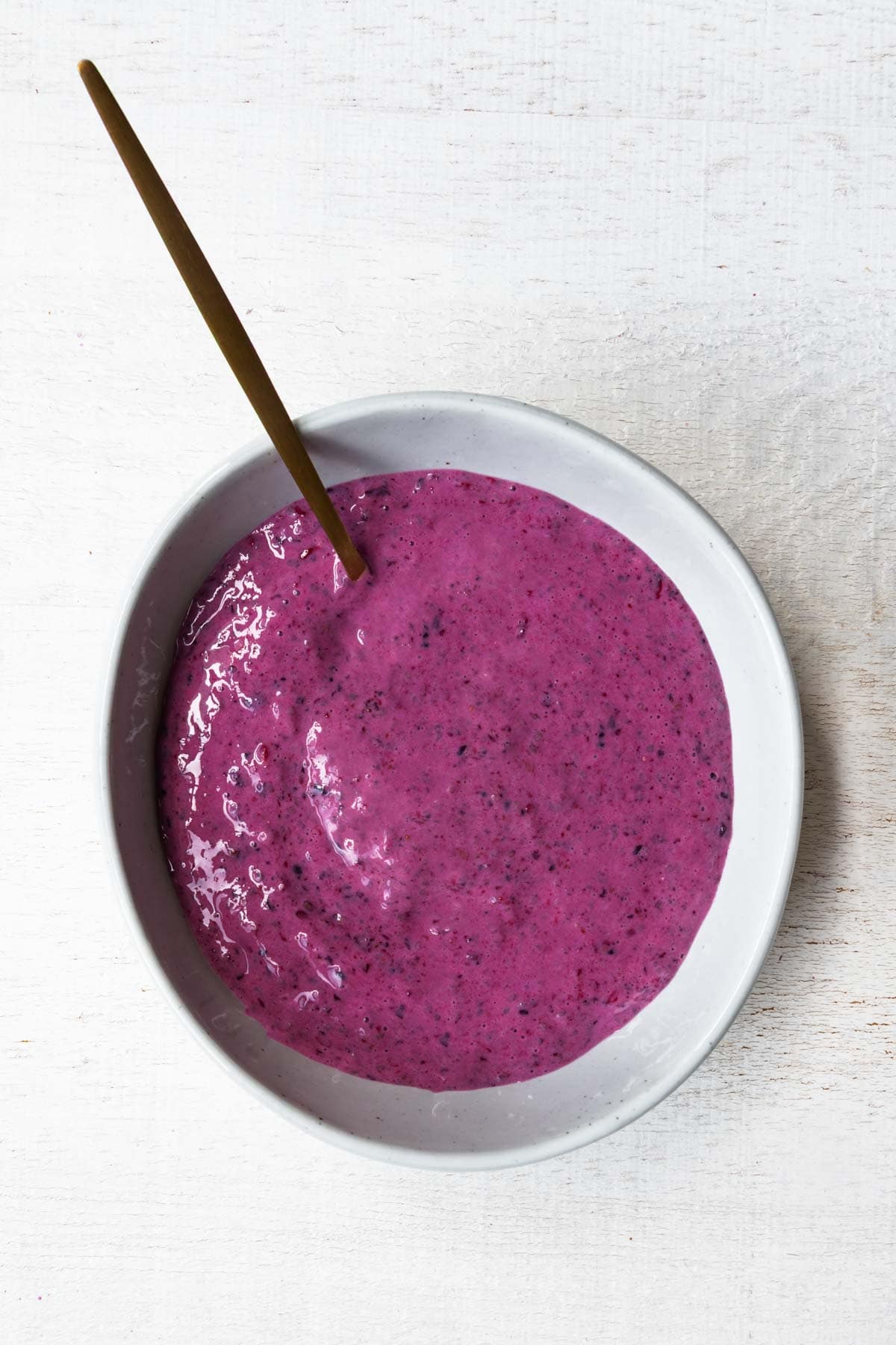 High-protein berry chia pudding with yogurt in a white bowl.
