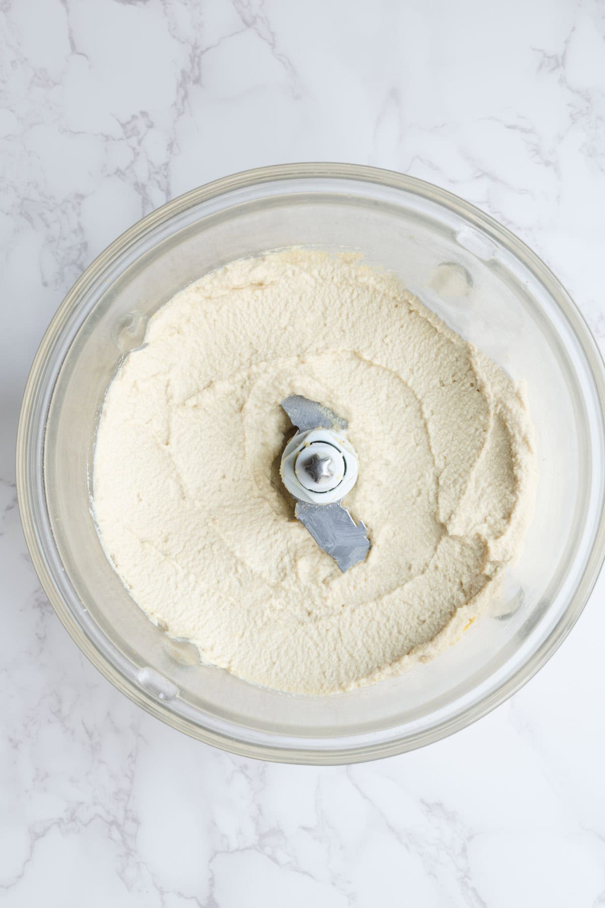 Creamy white spread in a food processor.