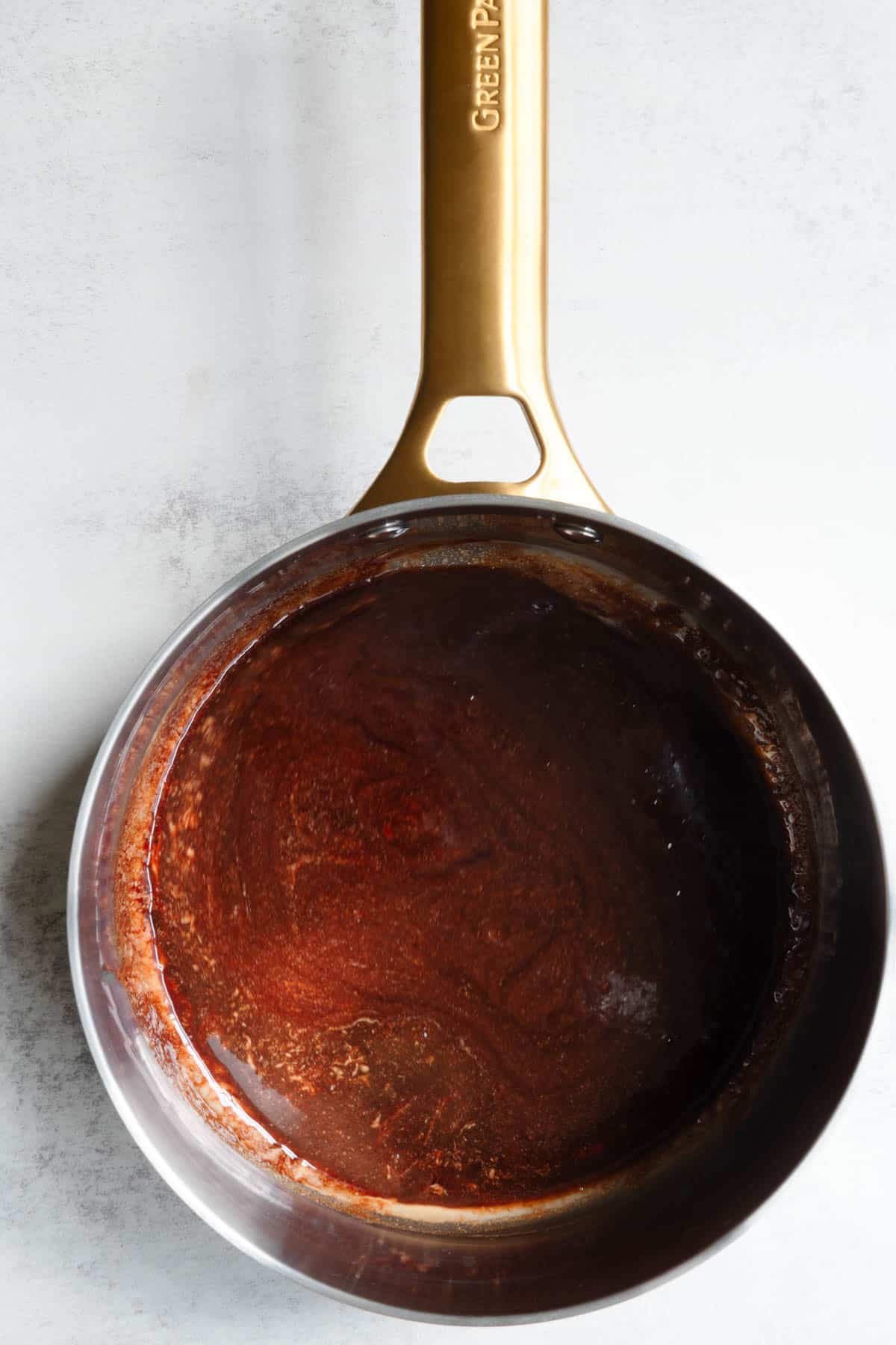 Warmed date syrup and tahini in a saucepan.