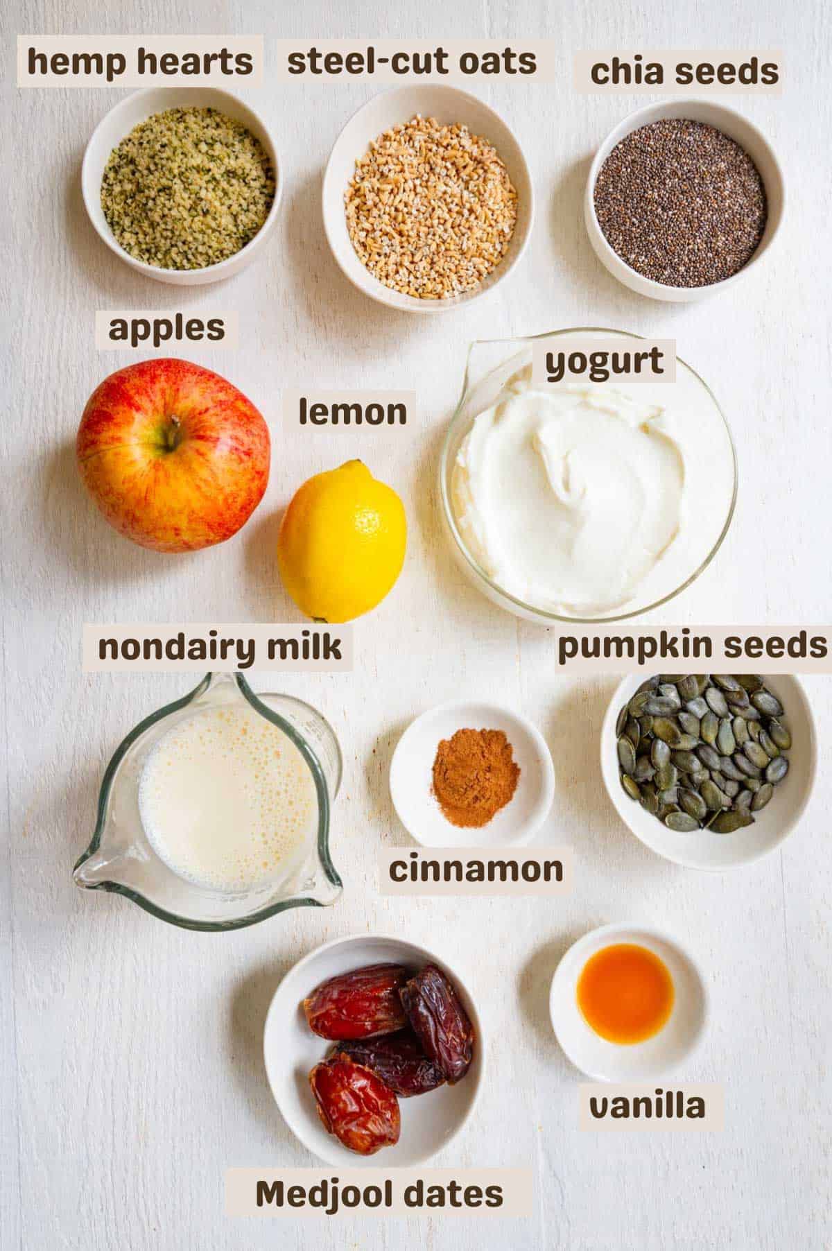 Chia seeds, steel-cut oats, hemp hearts, dates, vanilla, pumpkin seeds, nondairy milk, cinnamon, yogurt, lemon, and apple.