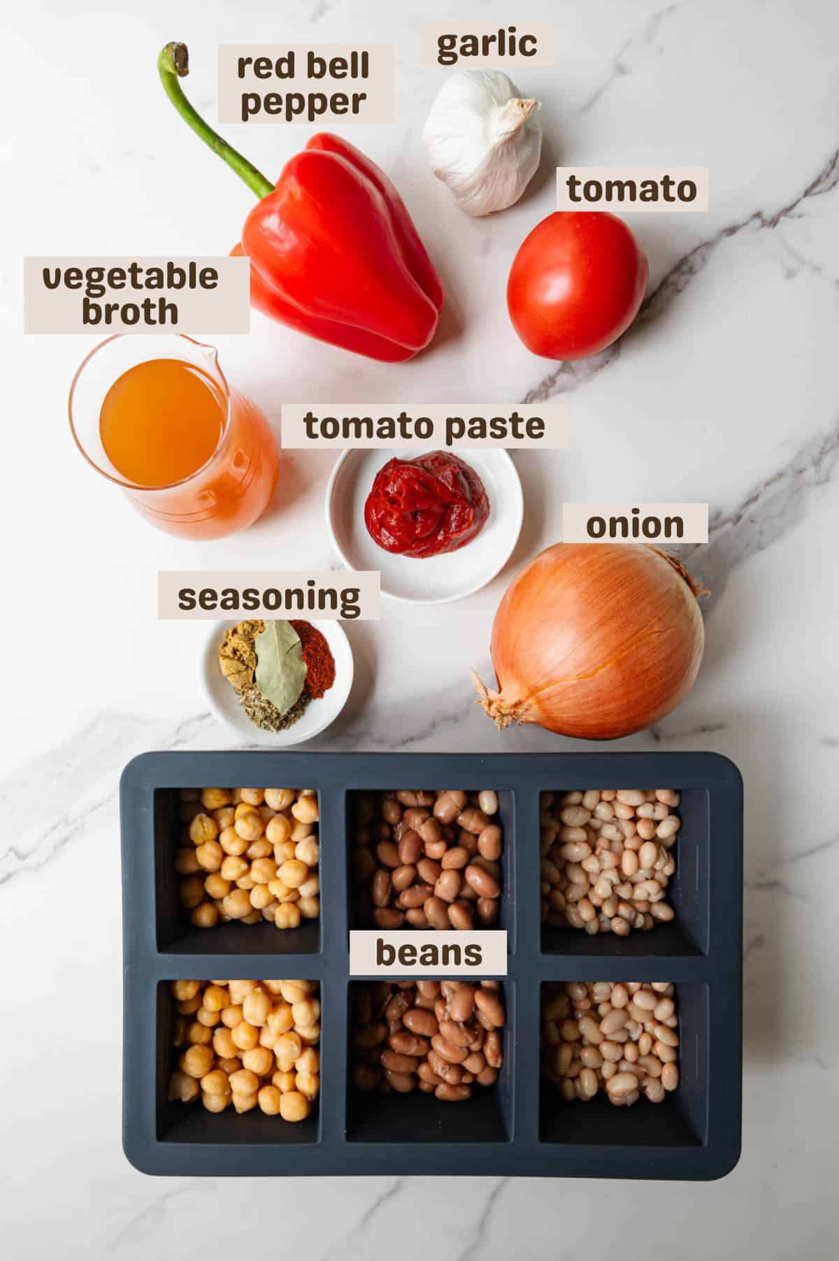 Tomatoes, red bell pepper, onion, tomato paste, seasoning, garlic, beans, and vegetable broth.