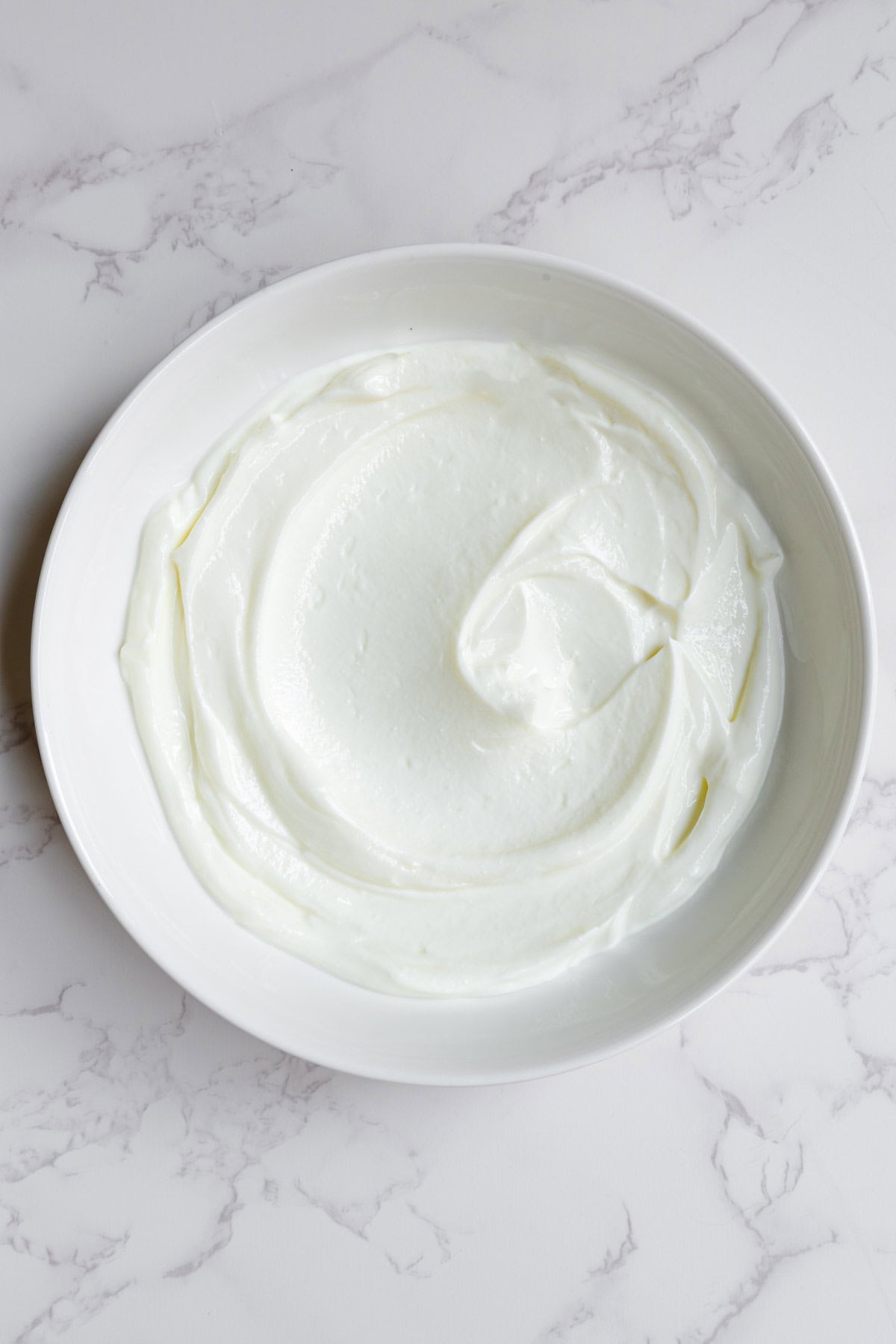 Greek yogurt in a white bowl.