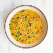 Red lentil soup with carrots in a bowl.